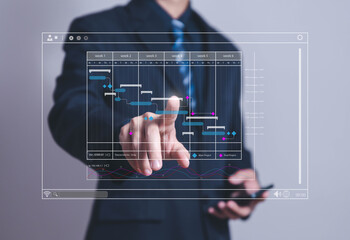 Wall Mural - business manager managing business planning project schedules in the office. Gantt chart showing on virtual screen.	
