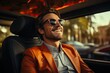Cheerful young man in orange jacket and sunglasses smiling while driving a car