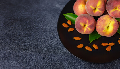 Wall Mural - Harvest of peaches for food or juice. fresh organic fruit, vegan food. Large peaches on dark table background, selective focus.