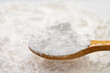 Wheat starch on wooden spoon. spice or seasoning as background. close-up Wheat starch