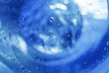 Wall Mural - Oil bubbles close up. circles of water macro. abstract light blue background