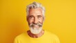 © WS Studio 1985 - Happy mature old bearded man, smiling cool mid aged gray haired older senior hipster wearing yellow t-shirt standing isolated on yellow background looking at camera, close up headshot, generative ai