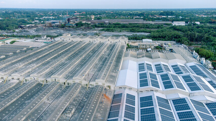 Wall Mural - Aerial view of solar roof of the factory in eco environment. Solar Cells panel reflection with the sun and turn to blue color in industrial area. Concept of energy recycle.