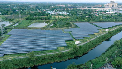 Wall Mural - Solar cells farming beside with rivers and factories in industrial area. Green World concept with the ecosystem with technology recycling.