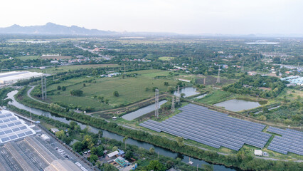 Wall Mural - Solar cells farming beside with rivers and factories in industrial area. Green World concept with the ecosystem with technology recycling.