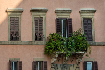 Renaissance balcony on a mediterranean building with shutters