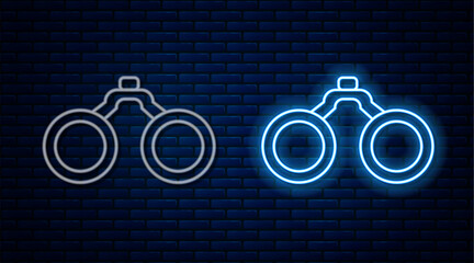 Canvas Print - Glowing neon line Binoculars icon isolated on brick wall background. Find software sign. Spy equipment symbol. Vector