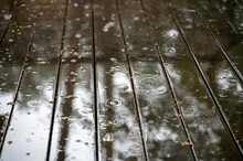 Rain Drops On Wet Wooden Floor Of Patio At Raining Day