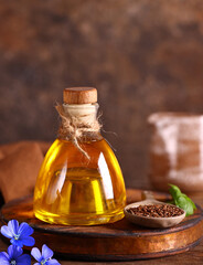 Poster - linseed oil in a bottle on a wooden table