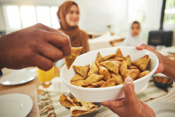 Canvas Print - Food, samosa and muslim with hands of people at table for eid mubarak, Islamic celebration and lunch. Ramadan festival, culture and iftar with closeup of family at home for fasting, islam or religion