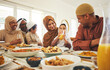 © Azee/peopleimages.com - Food, love and muslim with big family at table for eid mubarak, Islamic celebration and lunch. Ramadan festival, culture and iftar with people eating at home for fasting, islam and religion holiday