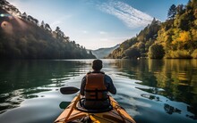 A Person In A Kayak Paddling Down A River. Ai