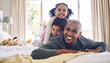 © Azee/peopleimages.com - Bed, playful and portrait of a father with children for love, care or bonding in the morning. Happy, family and a young dad with kids in the bedroom of a house for quality time and playing together