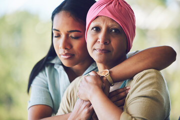 Love, hug and woman with her mother with cancer hugging, bonding and spending time together. Happy, sweet and portrait of a sick mature female person embracing her adult daughter in an outdoor garden