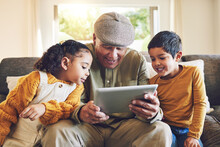 Young Kids, Grandfather And Tablet, Relax Together And Watch Cartoon Or E Learning With Games While At Home. Bonding, Love And Spending Quality Time, Old Man And Grandkids With Gadget And Internet