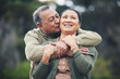 © Azee/peopleimages.com - Hug, kiss and senior couple in nature, thinking and love during retirement together. Happy, idea and an elderly man and woman with affection in a garden or park for support or care in marriage