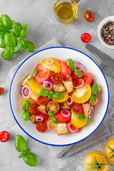 Wall Mural - traditional Italian Panzanella salad with tomatoes, onion, fresh basil and bread. Vegetarian dish. top view