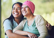 © Azee/peopleimages.com - Love, bonding and woman with her mom with cancer hugging, sitting and spending time together. Happy, sweet and sick mature female person embracing her adult daughter with a smile in outdoor garden.