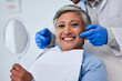© Nadia L/peopleimages.com - Happy senior woman, teeth and dentist for dental care, appointment or checkup at clinic. Portrait of elderly female person smile for tooth whitening, cleaning or oral, mouth and gum care at hospital