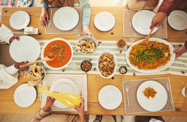 Wall Mural - Food, Eid Mubarak and above of family eating at table for Islamic celebration, festival and lunch together. Ramadan, religion and hands with meal, dish and cuisine for fasting, holiday and culture