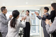 © Blue Jean Images - Cheerful Chinese business people applauding in office
