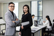 © Blue Jean Images - Portrait of successful Chinese business people in office