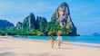 © Fokke Baarssen - men and women relaxing on the beach during a vacation in Thailand Railay Beach Krabi.