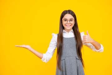 Sticker - Look at advert. Teenager child points aside shows blank copy space for text promo idea presentation, poses against yellow background.