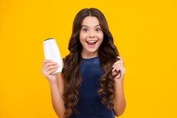 Poster - Child teen girl with shampoos conditioners and shower gel. Long hair care of teenager. Presenting cosmetic product, shampoo bottle. Happy girl face, positive and smiling emotions.