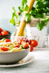 Wall Mural - Italian cuisine. Pasta with olive oil, garlic, basil and tomatoes. Spaghetti with tomatoes