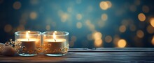 Burning Candles On Wooden Table In Front Of Bokeh Background
