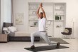 © New Africa - Man doing morning exercise on fitness mat at home