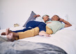 Bed, relax and happy elderly couple laughing, resting and enjoy time together, cuddle and retirement wellness. Hug, home bedroom and senior man, old woman or people laugh, talking and in funny chat