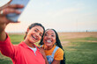 © LuneVA/peopleimages.com - Selfie, happy and friends in nature for social media memory, update or together in summer. Smile, diversity and women taking a digital photo at a park for travel, vacation or relax on a holiday