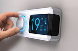 Fototapeta Panele - Hand turning a home thermostat knob to set temperature on energy saving mode. Celsius units. Composite image between a photography and a 3D background.