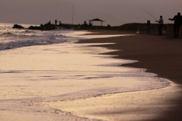 Wall Mural - Beautiful view of the sea, waves and mountains at sunset. The horizon above the water.