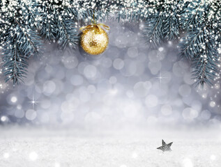 Poster - Golden Christmas ball on spruce branch isolated on gray background. Christmas background with shining lights and snow.