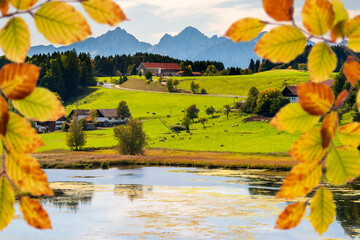 Wall Mural - panoramic view to rural landscape with mountain range and lake at autumn