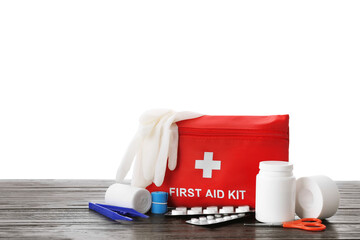 Wall Mural - First aid kit, scissors, gloves, pills, plastic forceps and elastic bandage on wooden table against white background