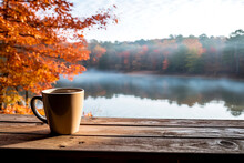 Cup Of Coffee On Overlooking Lake Autumn Leaves