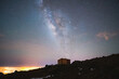 © ADDICTIVE STOCK - Amazing view of starry night with glowing stars and house on highland rocks