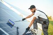Indian worker cleaning solar panels.