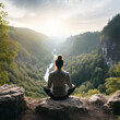 © nick - person sitting on a rock meditating in nature