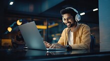 Excited And Futuristic Young Indian Man Working On Laptop With Headphone Generative Ai