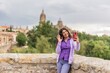 © Sangiao_Photography - Smartphone technology holiday vacation. Latin American mid-female. Lifestyle selfie in Salamanca.