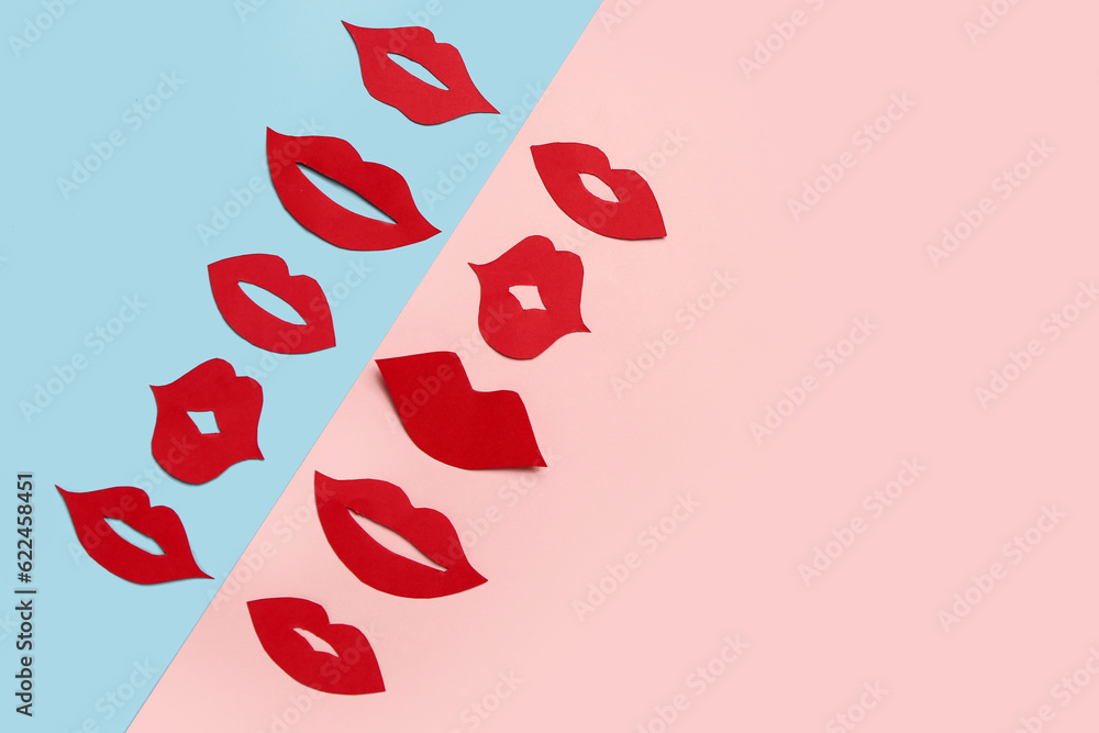 Red paper lips on color background