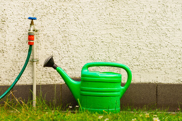 Wall Mural - Watering green can on garden plot