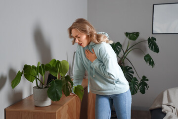 Wall Mural - Young woman having panic attack at home