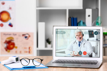 Canvas Print - Video chat with doctor on modern laptop in clinic