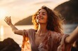 canvas print picture - Backlit Portrait of calm happy smiling free woman with open arms and closed eyes enjoys a beautiful moment life on the seashore at sunset 